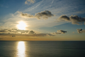 Romantic colorful sunset at the sea. View of Beautiful glorious golden sunset and golden hour above the sea in evening.