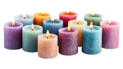 A collection of colorful candles lit and arranged beautifully for a cozy ambiance in a serene setting.