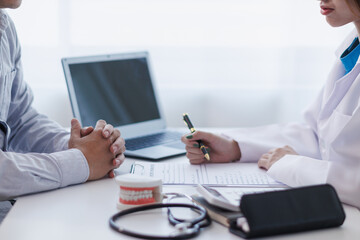 woman consults dentist about her toothache for treatment in dental clinic and dentist gives advice on right symptoms and treatment method for patient. concept consulting dentist about dental treatment