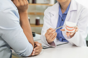 woman consults dentist about her toothache for treatment in dental clinic and dentist gives advice on right symptoms and treatment method for patient. concept consulting dentist about dental treatment