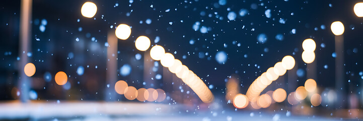 Abstract bokeh lights and falling snow create a magical winter night atmosphere   