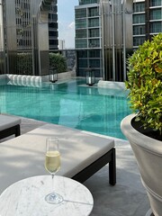 swimming pool in hotel with a glass of wine