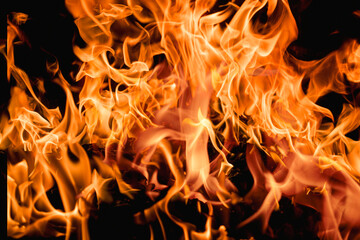 Fototapeta premium Fire over black background. Fire sparks background. Abstract blaze flames background. Burning fire. Texture of fire on a black background.