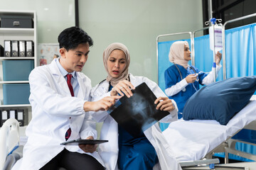 Medical team working on digital tablet healthcare doctor technology tablet using computer analyzed the results of medical reports at the hospital.