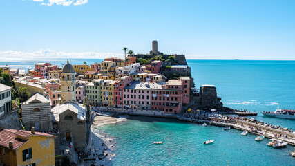 Vibrant coastal village of Cinque Terre bathed in sunlight on a clear day