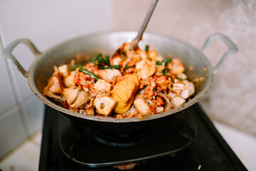 A pan-cooked dish featuring tofu, eggs, chilies, and vegetables.