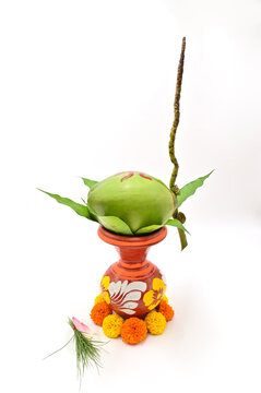 DECORATIVE MANGAL GHAT WITH FRESH MARIGOLD AND GREEN COCONUT ON ISOLATED BACKGROUND.