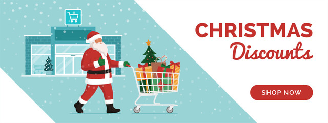 Cheerful Santa Claus pushing a shopping cart full of Christmas gifts