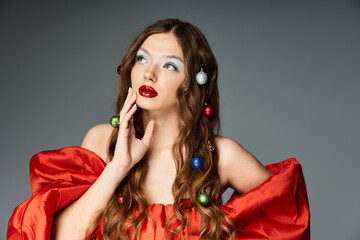 The young woman captivates with her vibrant red attire and playful holiday decorations in her hair.