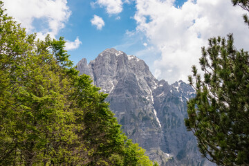 Obraz premium Majestic mountain ridge Maja Boshit towering over rugged landscape in Albanian Alps (Accursed Mountains) in Northern Albania. Scenic hiking trail from Valbona to Theth. Wanderlust in alpine wilderness