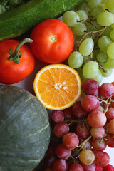 Various seasonal fruits and vegetables on white background. Summer and fall produce. Top view.