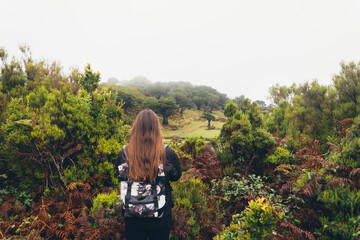 Woman Hiking in a Foggy Forest