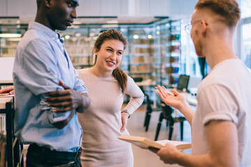 Cheerful students preparing for exam together