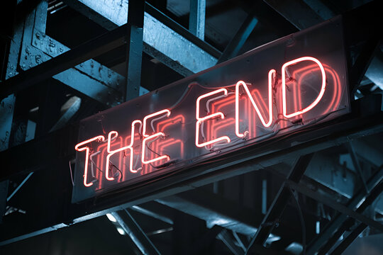 A glowing neon sign reads "THE END," set against a dark industrial backdrop, evoking a sense of closure and finality.