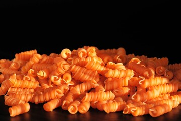 Close-up noodle made of red lentils on a black background