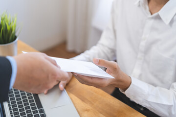 Good job Asian manager business man giving financial reward in an envelope, business letter extra salary to company employee, male worker office hand received premium bonus, getting cheque from boss.