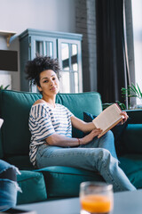 Obraz premium Ethnic woman with book relaxing near concentrated Black man