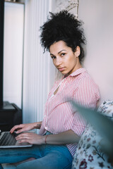 Thoughtful female surfing laptop in room