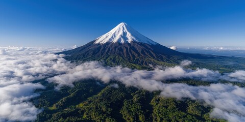 Majestic Snow capped Volcano Above Clouds Aerial View
