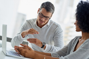 Ideas, teamwork and people with laptop, office and discussion for campaign, collaboration and talking. Digital, man and planning with woman, promotions coordinator and drive sales to company and desk