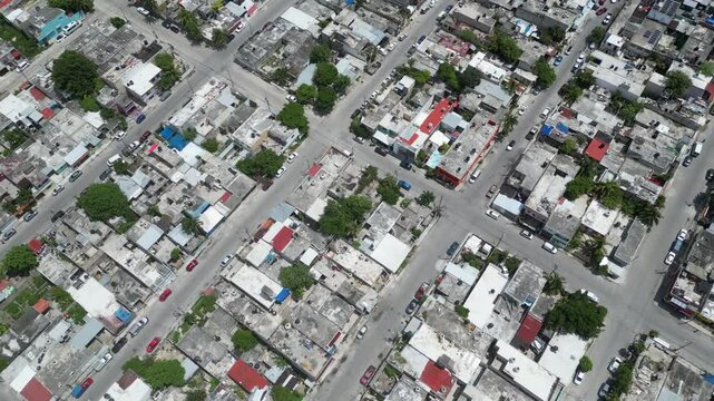 Aerial top-down view high altitude of slum, a heavily populated urban informal settlement characterised by substandard housing and squalor poor living conditions streets and rusty metal home roof tops