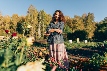Smiling woman with folded arms , finding fulfillment and joy in her eco-friendly homestead Autumn...