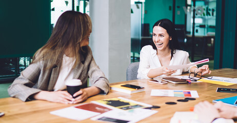 Joyful women laughing during meeting
