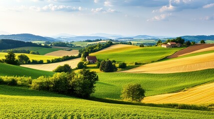 Fototapeta premium Breathtaking view of rolling hills and lush fields under a clear sky, showcasing the beauty of nature and agricultural landscapes.
