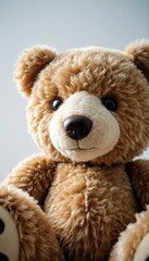 Obraz premium Close-up of a fluffy teddy bear smiling warmly against a bright background
