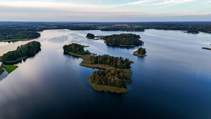 Drone aerial footage of Trakai Castle in the evening. Lakes, forests and islands around. Aerial drone shot of red brick medieval castle on island in Trakai, Vilnius region, Lithuania. 