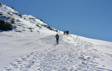 walking on the snowy peaks on a beautiful winter day