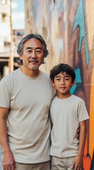 Fototapeta premium The senior man and young boy pose together against a colorful urban mural background