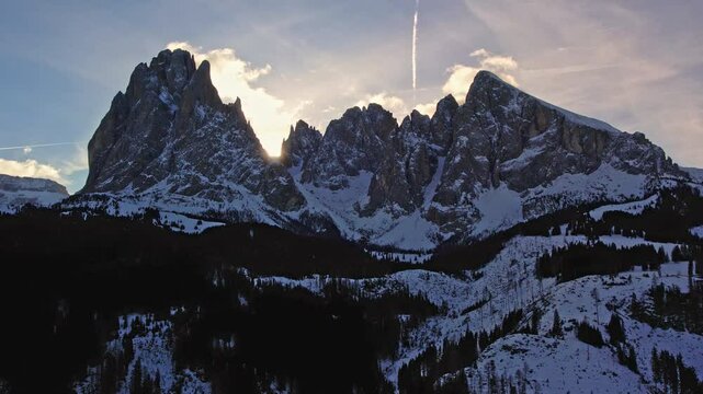 Drone footage capturing a stunning sunset over the snowy peaks of the Dolomites. Langkofel