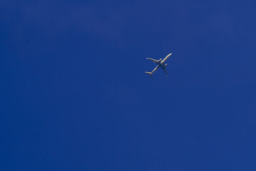 Commercial Airplane Flying in Clear Blue Sky
