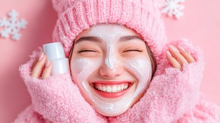 Young woman with a bright smile applying face mask while wearing winter attire indoors