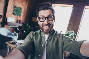 Photo of positive good mood specialist dressed shirt smiling recording video indoors workstation...
