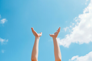 hands reaching out to sky, raised hands against a bright blue sky symbolizing freedom and hope