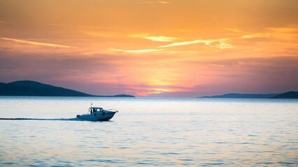 Motorboat yacht sunset on sea bay