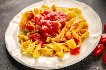 Tagliatelle pasta tomato sauce tasty food dish fresh gourmet food background on the table rustic food top view copy space