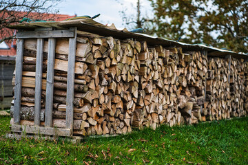 Storage of firewood for the fireplace stacked for outdoor drying. 