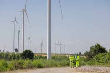 Engineers inspect the large wing turbine farm
