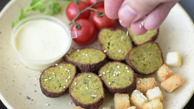 Hearty delicious fried falafel made from chickpeas, cumin, hummus with salt and spices on a dark concrete background