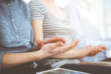 Business people clapping at meeting or conference, close-up of hands. Group of unknown businessmen...