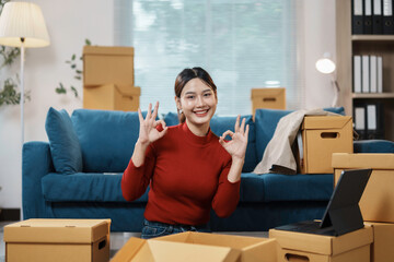 Young woman happily unpacks in her new, bright apartment, surrounded by boxes and furniture, feeling satisfied and content