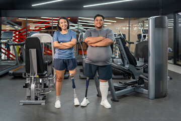 portrait persons with prosthetic leg standing arms crossed in gym fitness club