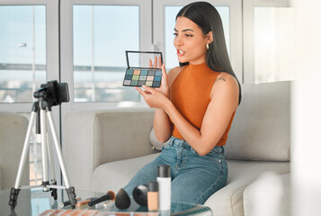 Live streaming, makeup palette and woman with phone in home for broadcast, content creation or...