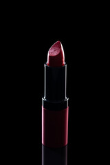 Red lipstick on black background. Lipstick is an indispensable make-up product for women