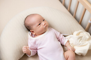 Newborn baby on baby crib