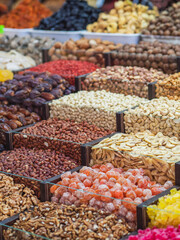 market stand with colorful dried fruits and nuts