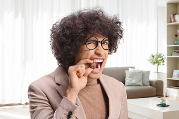 Young man trying to crack a walnut
